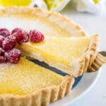 close up taking slice of lemon tart from the pan