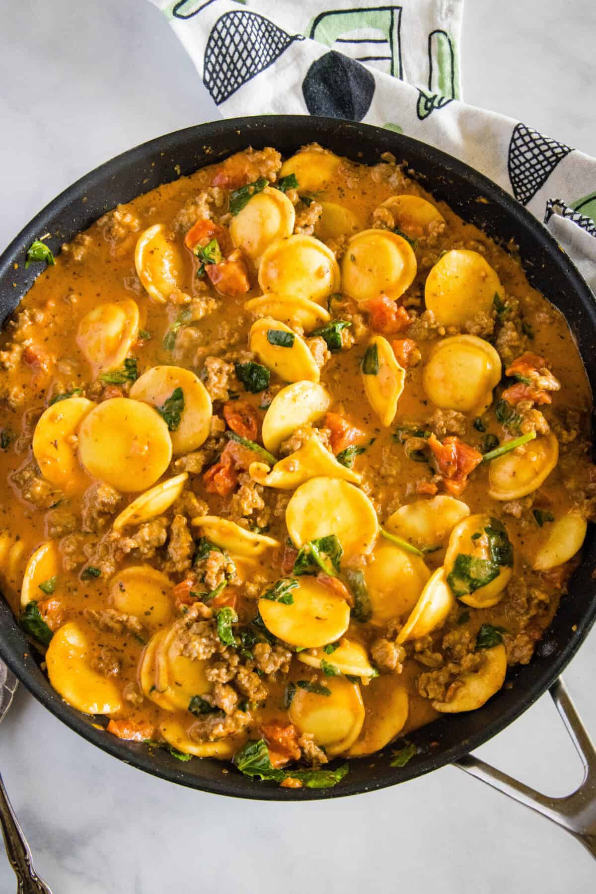 looking down on skillet with ravioli with sausage in it