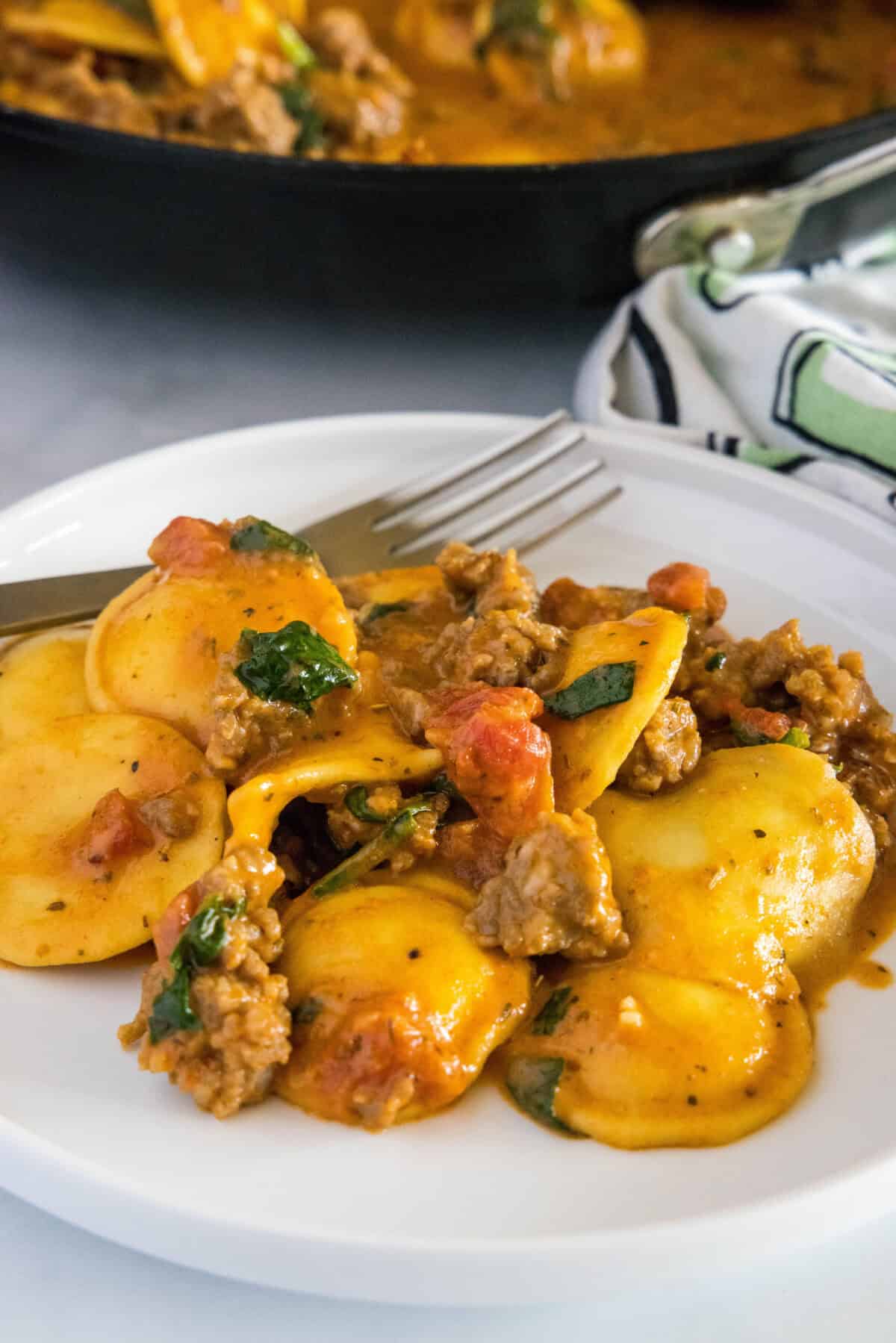 creamy ravioli with sausage on a plate