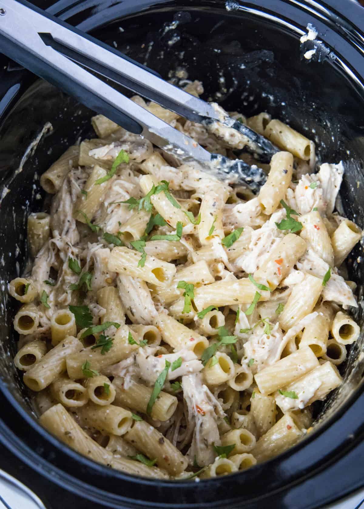 looking down on garlic parmesan chicken pasta in slow cooker