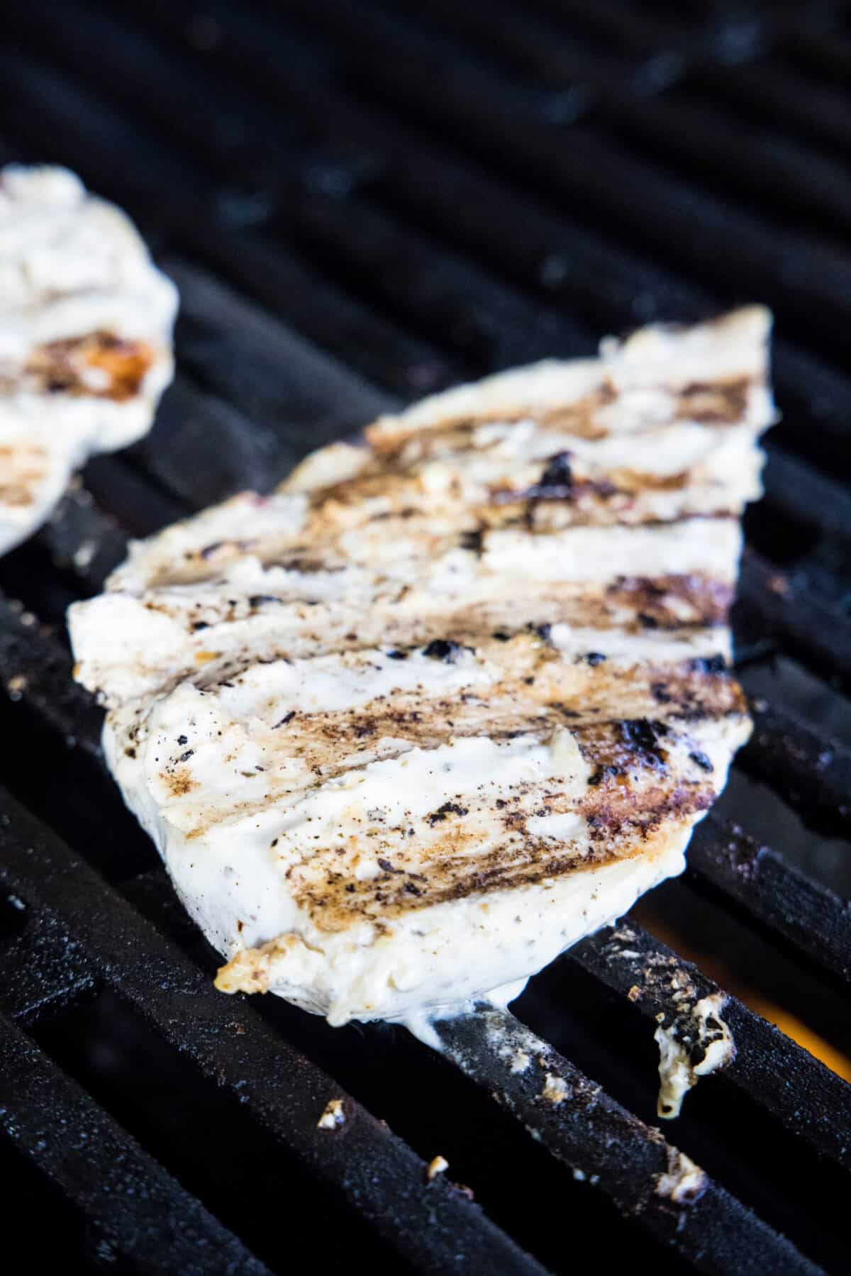 piece of chicken on the grill