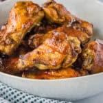 cropped close up baked chicken wings in a bowl