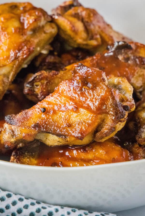 cropped close up baked chicken wings in a bowl