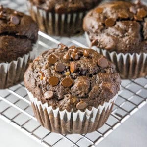 close up choolate banana muffin on cooling rack