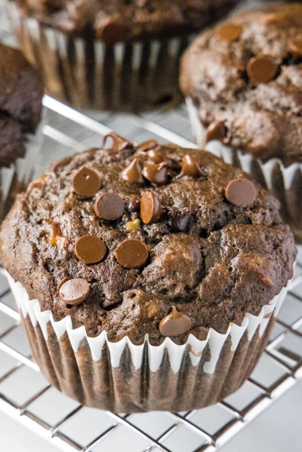 close up choolate banana muffin on cooling rack