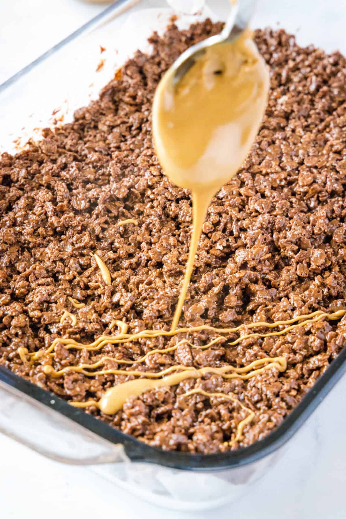dirzzling peanut butter over the top of bars