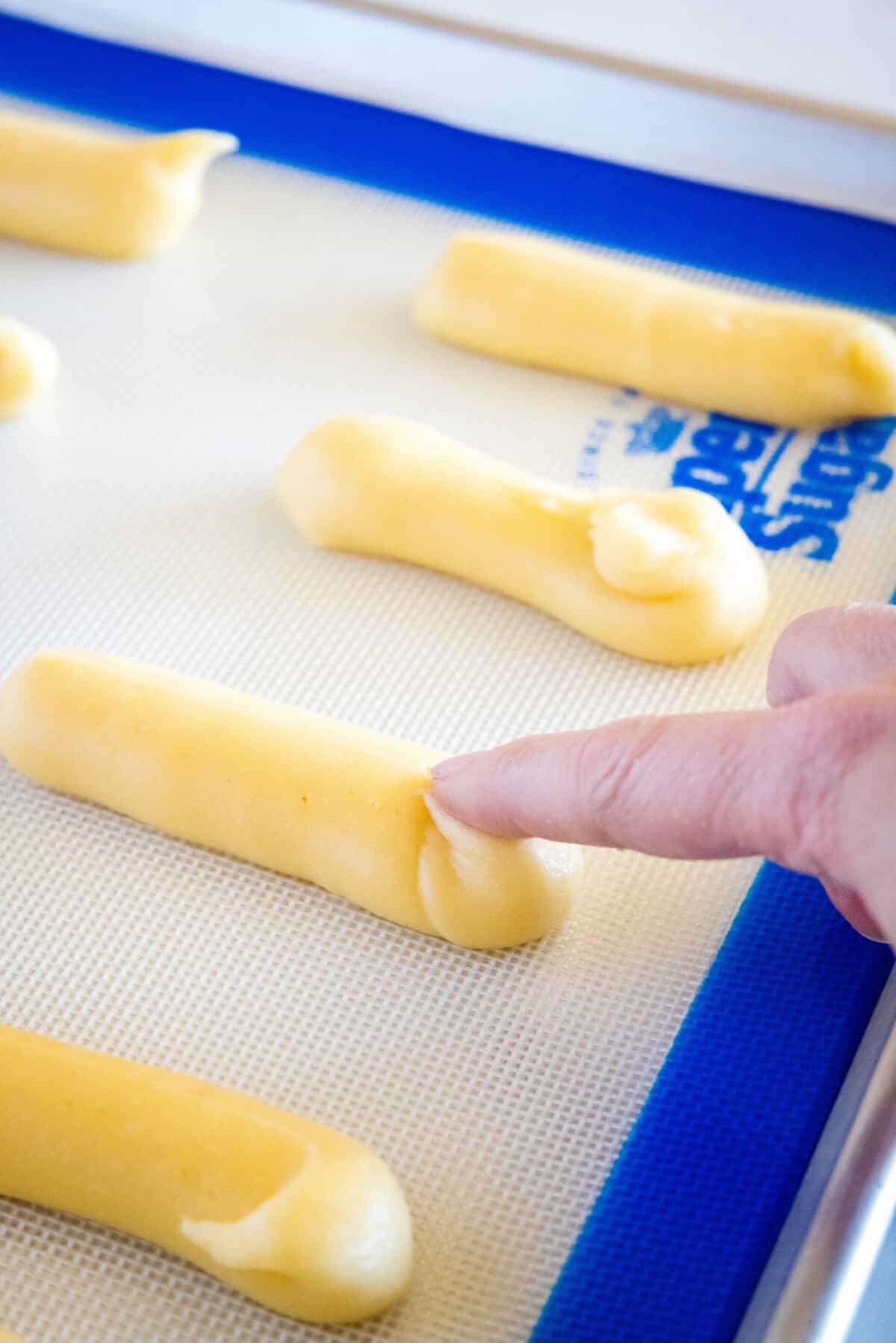 pushing down eclair dough