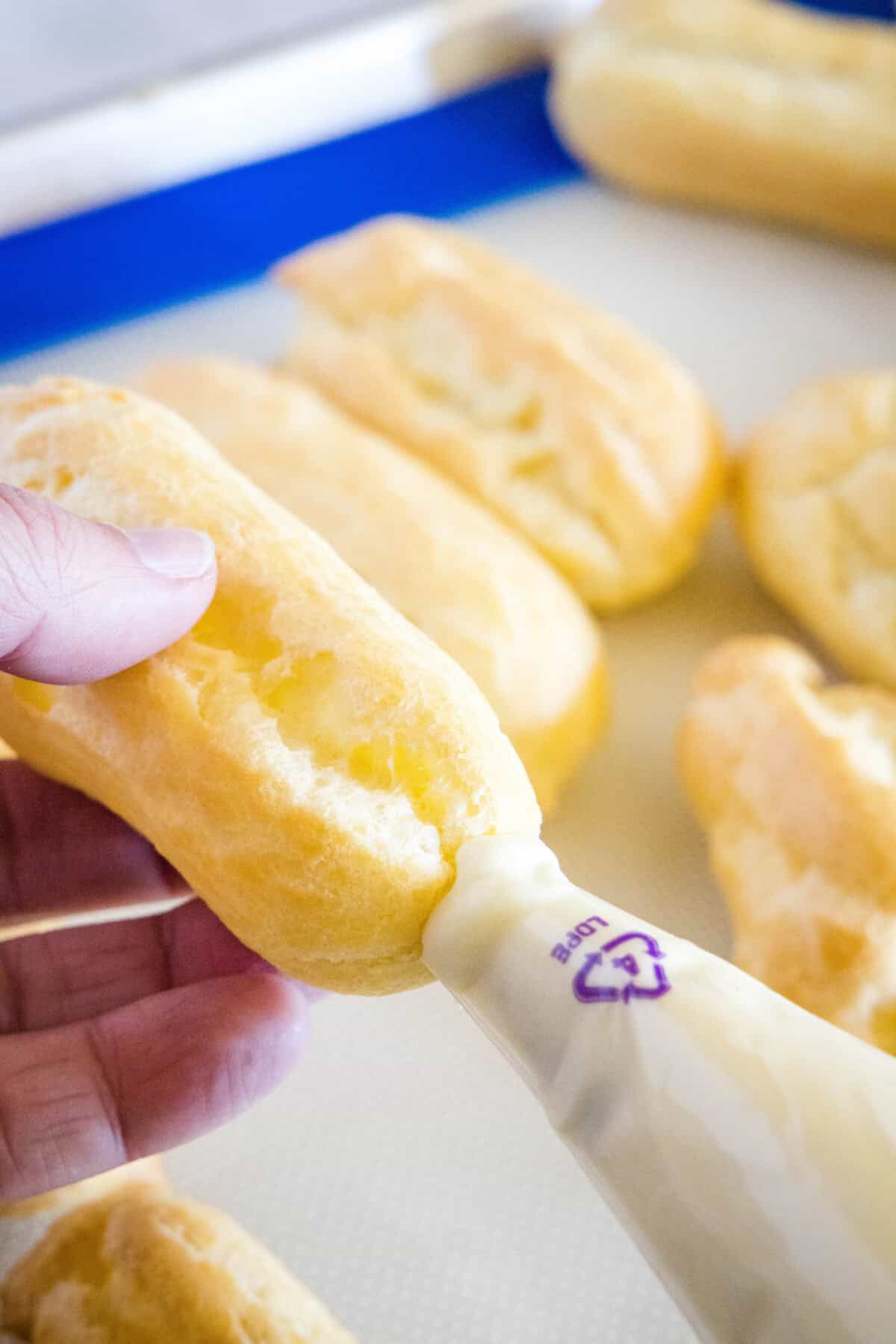 piping filling into eclairs