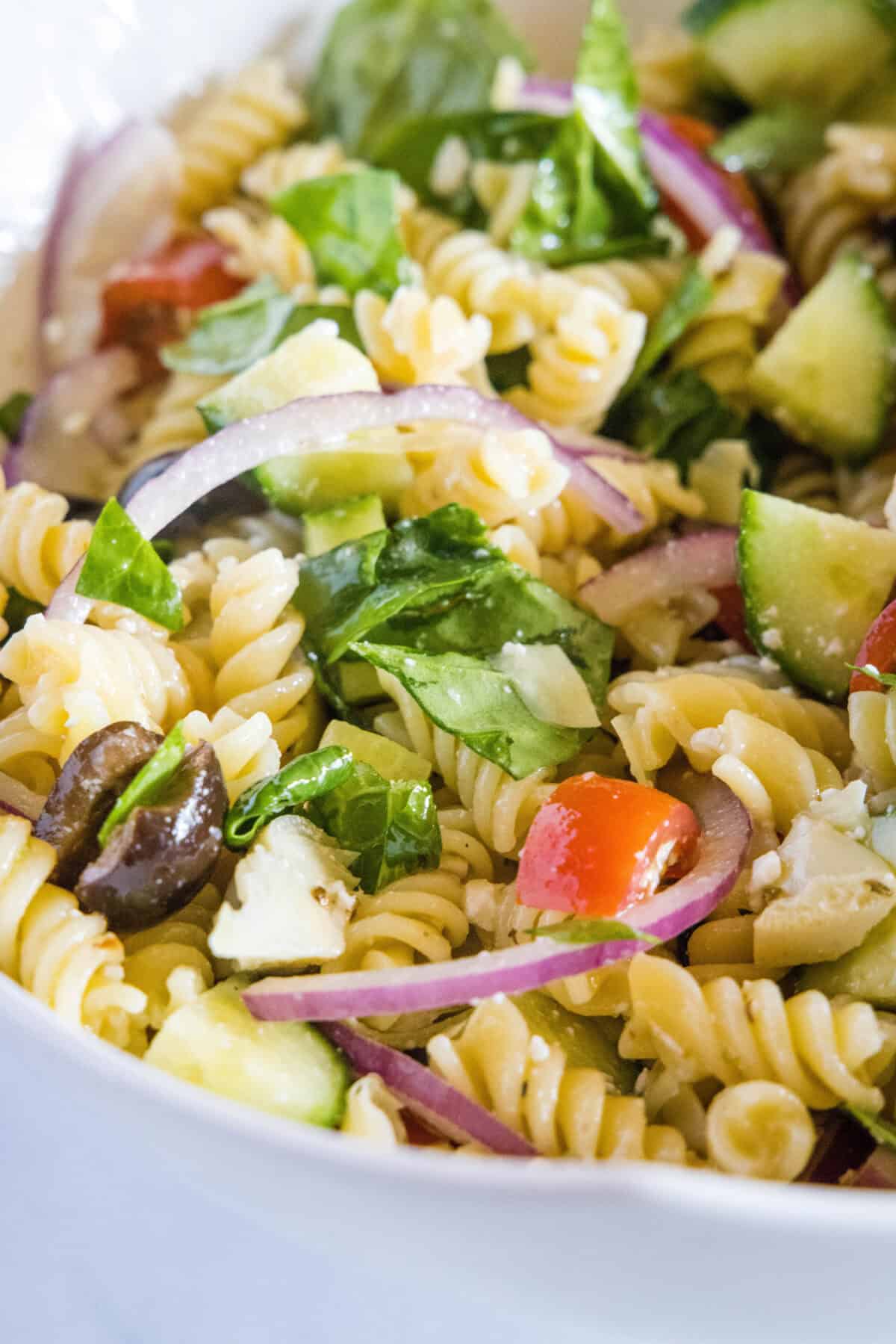 close up mediterranean pasta salad in serving bowl