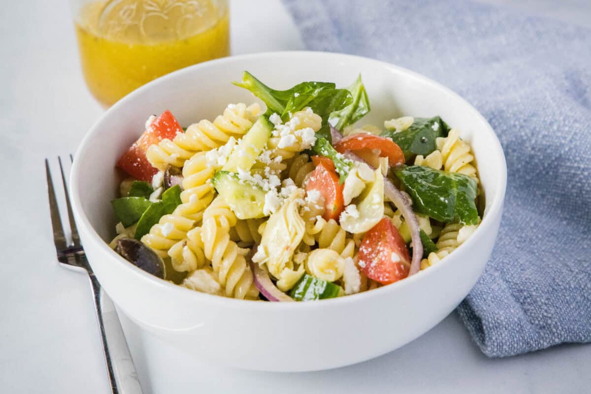 Mediterranean Pasta Salad is a fresh pasta salad with vegetables, olives, and feta. Topped with a light vinaigrette dressing for a cool and delicious dish.
