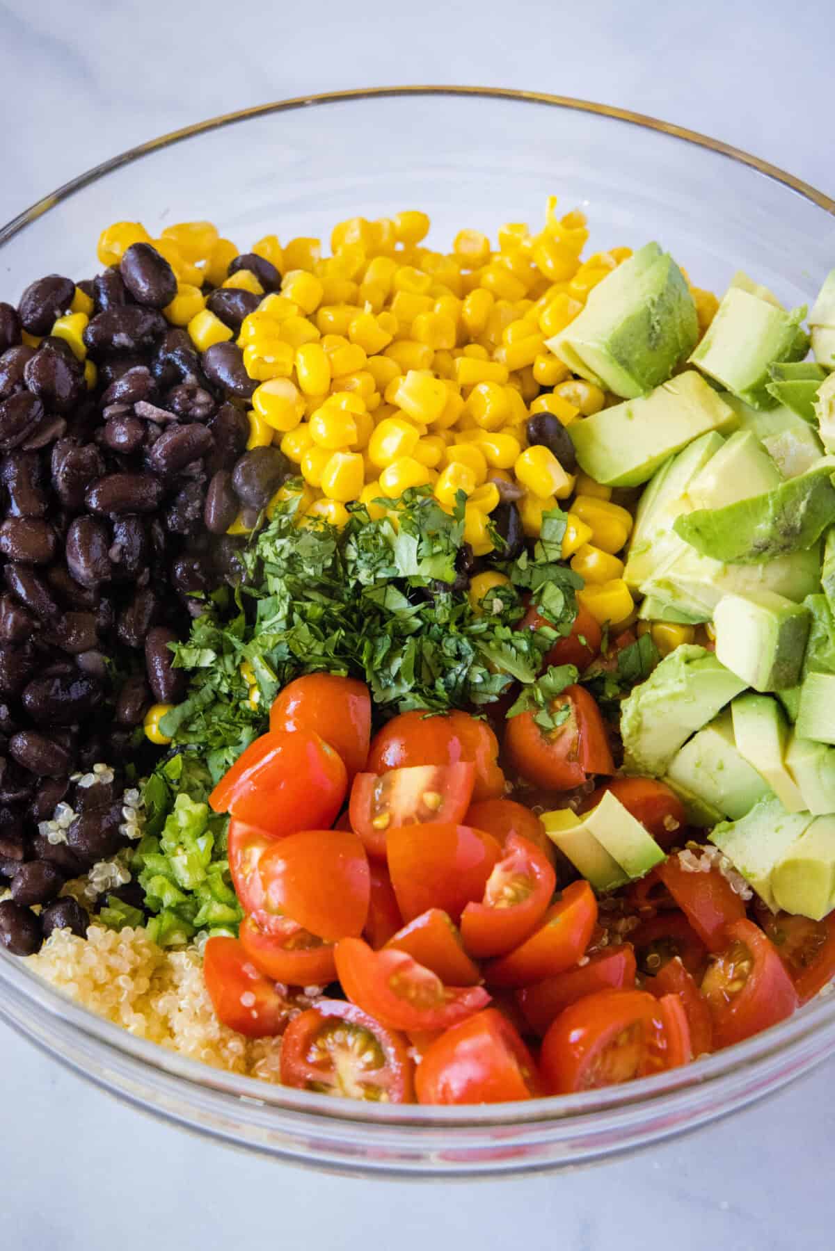 quinoa salad ingredients in a mixing bowl