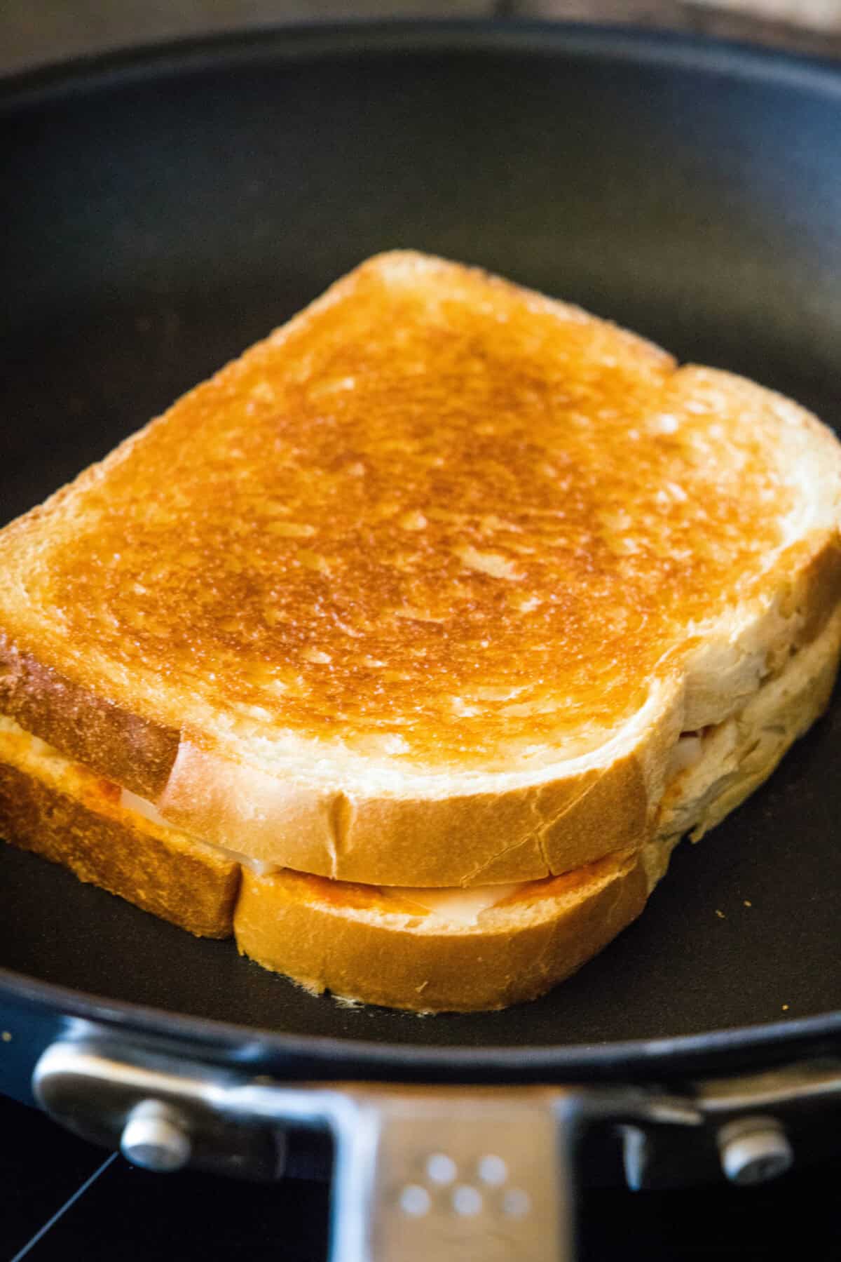 cooking grilled cheese in a skillet