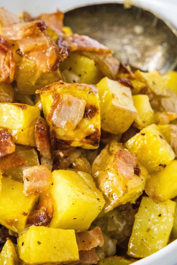 close up roasted potato salad in serving bowl
