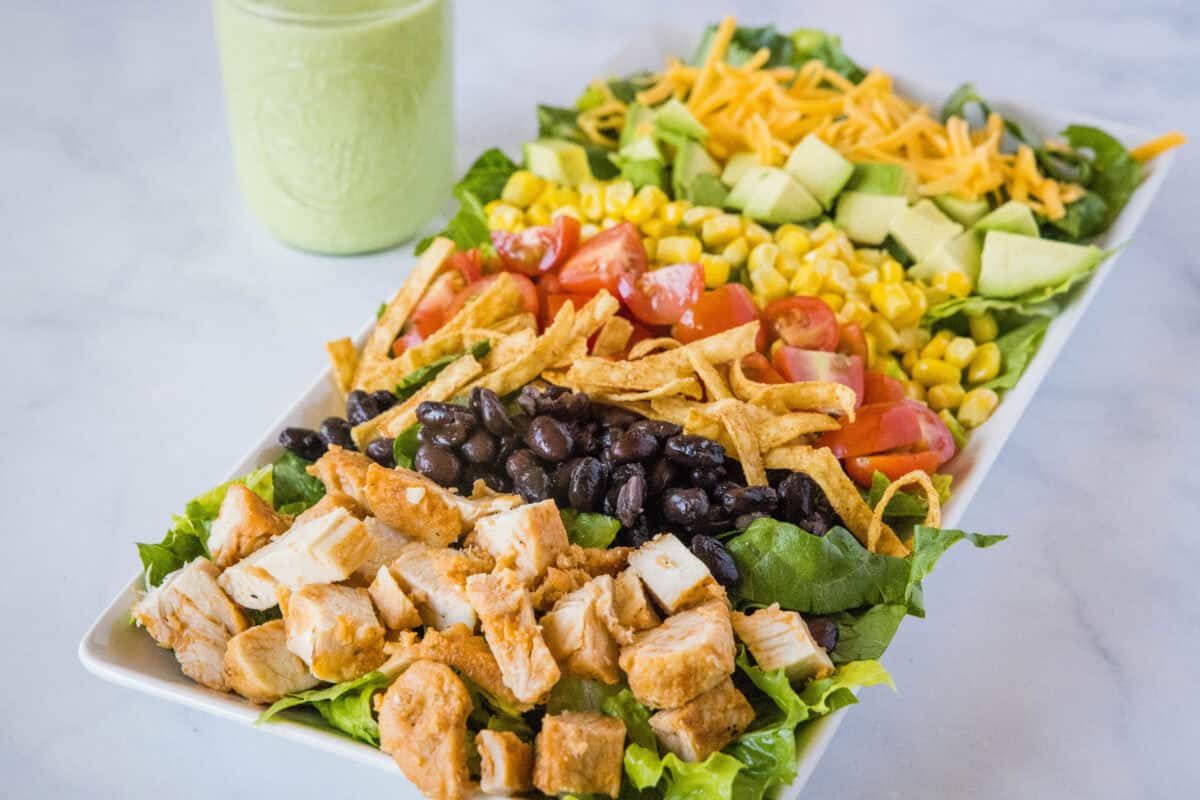 Southwest Cobb Salad is a bold, easy meal with chicken, corn, black beans and topped with a dreamy cilantro lime dressing. A fresh, hearty salad perfect for lunch or dinner.