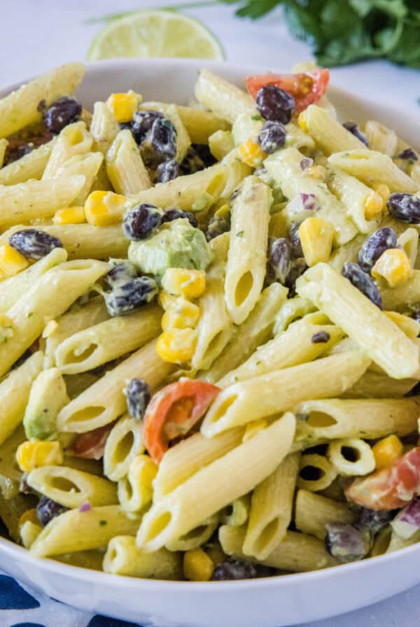 cropped close up avocado pasta salad in a bowl
