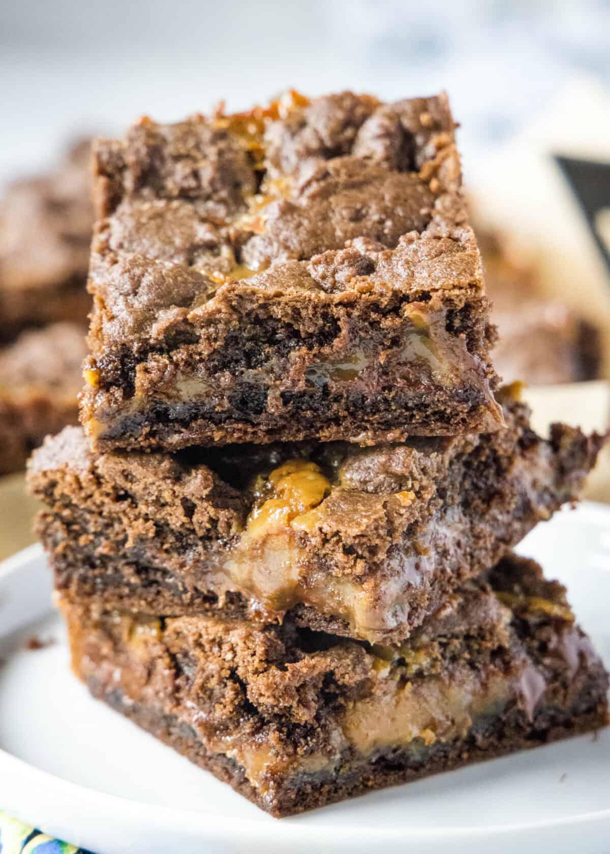 caramel layer bars stacked on a plate