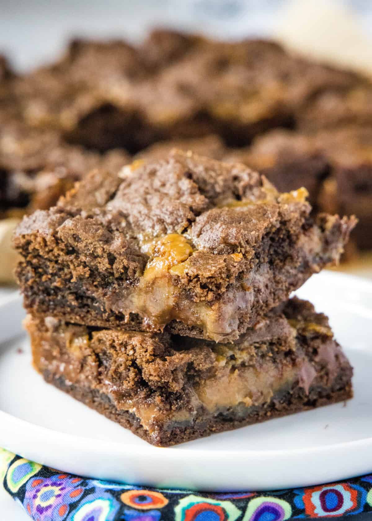 caramel layer bars stacked on a plate