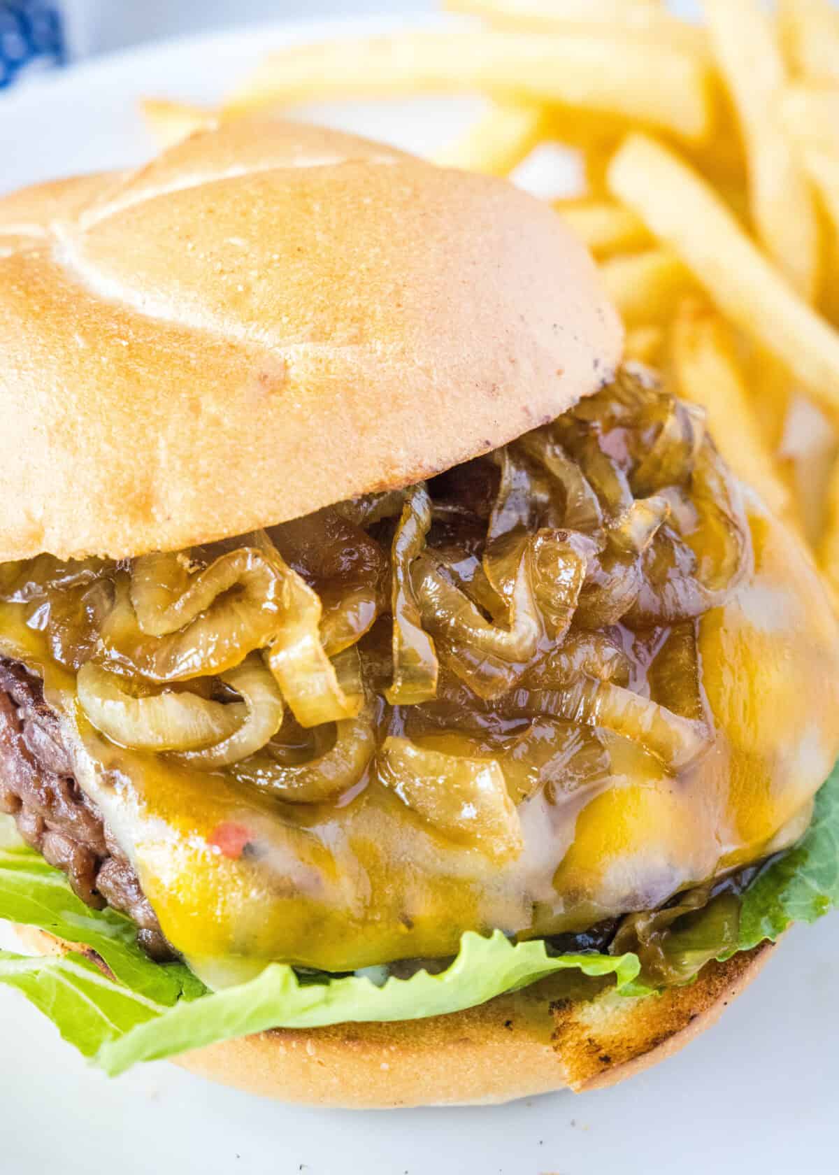 looking down at a caramelized onion burgers on a plate