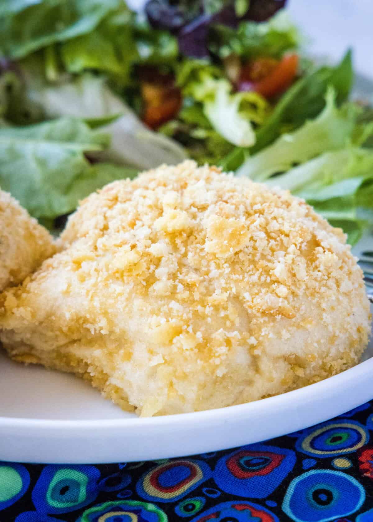 chicken roll ups on a plate with salad