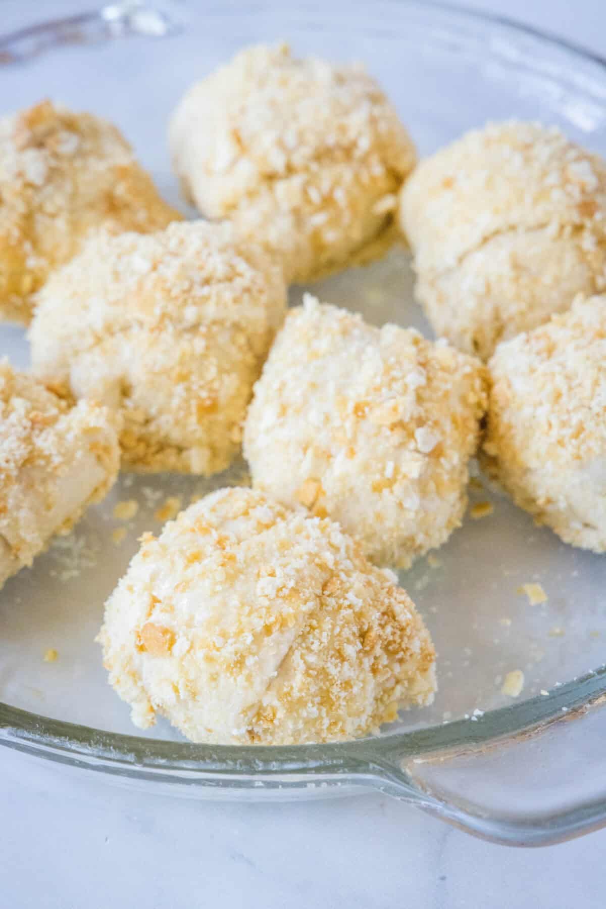 chicken roll ups coated with crackers ready for the oven