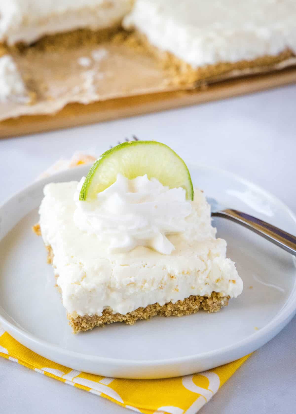 key lime bars on a plate with a fork