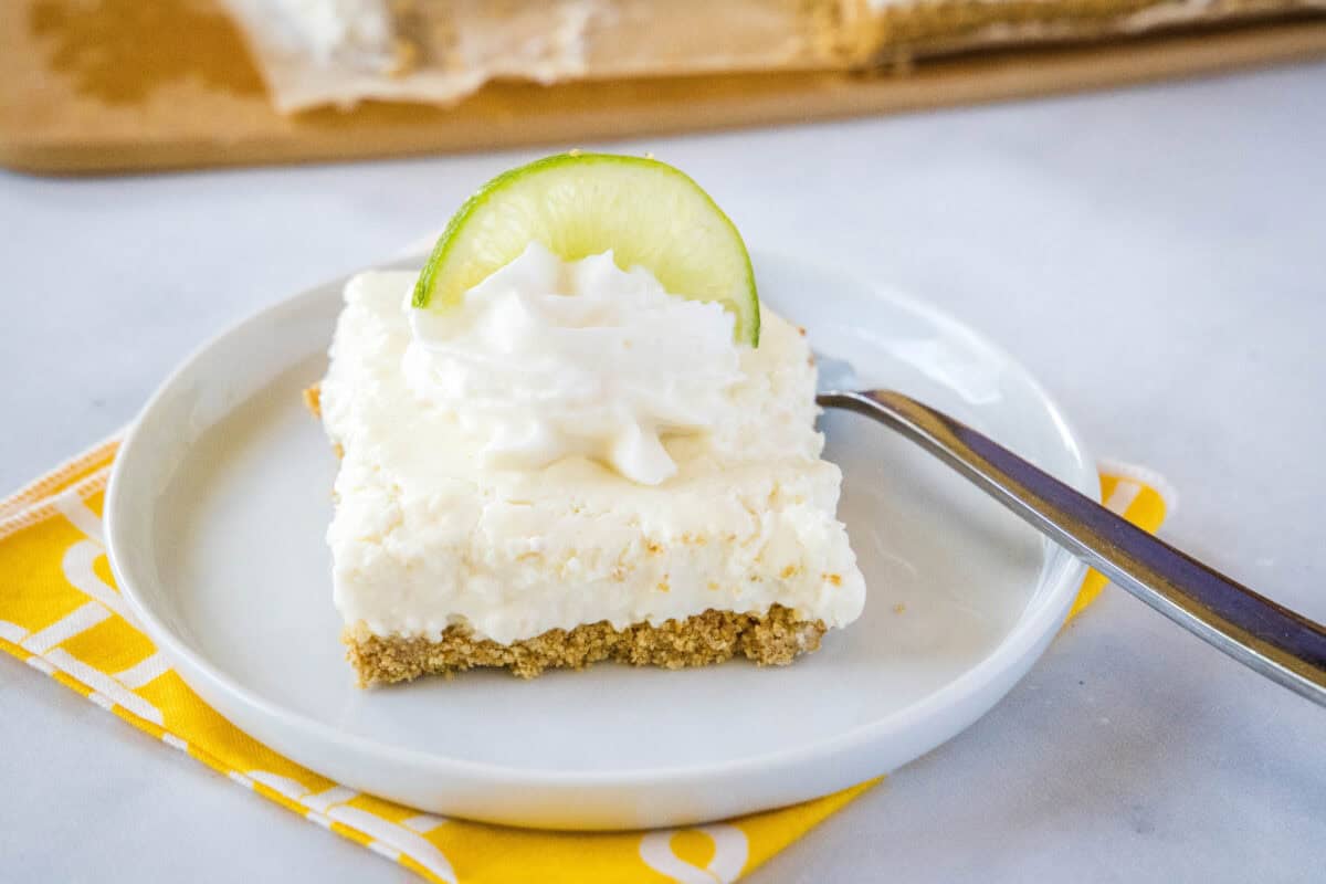 Key Lime Margarita Squares #recipe | Dinners, Dishes, and Desserts Key Lime Bars – Creamy, tangy bars with a smooth key lime filling over a buttery graham cracker crust. Chilled until set and easy to slice, they’re a refreshing dessert that’s perfect for warm days or make-ahead treats.