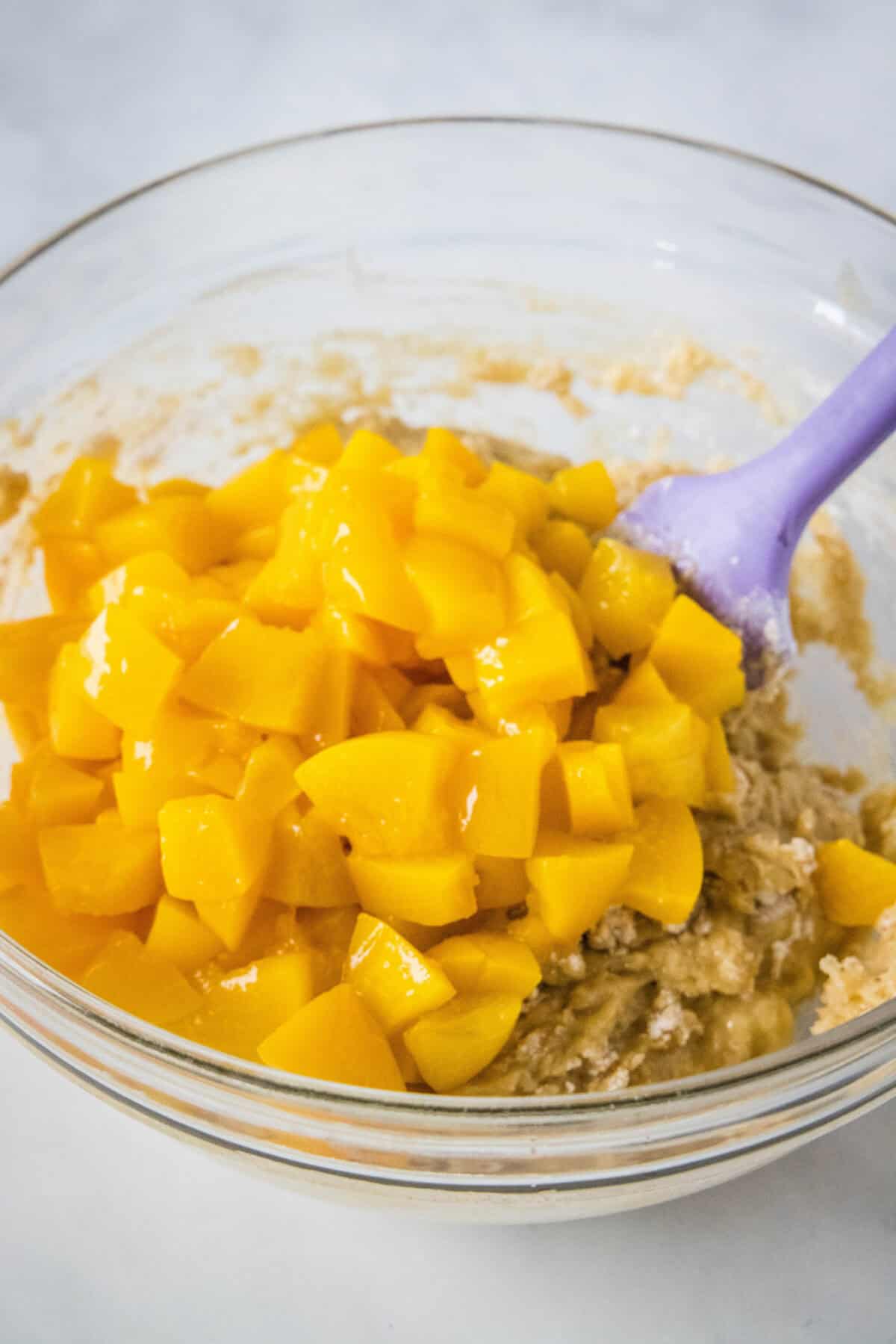adding peaches to muffin batter
