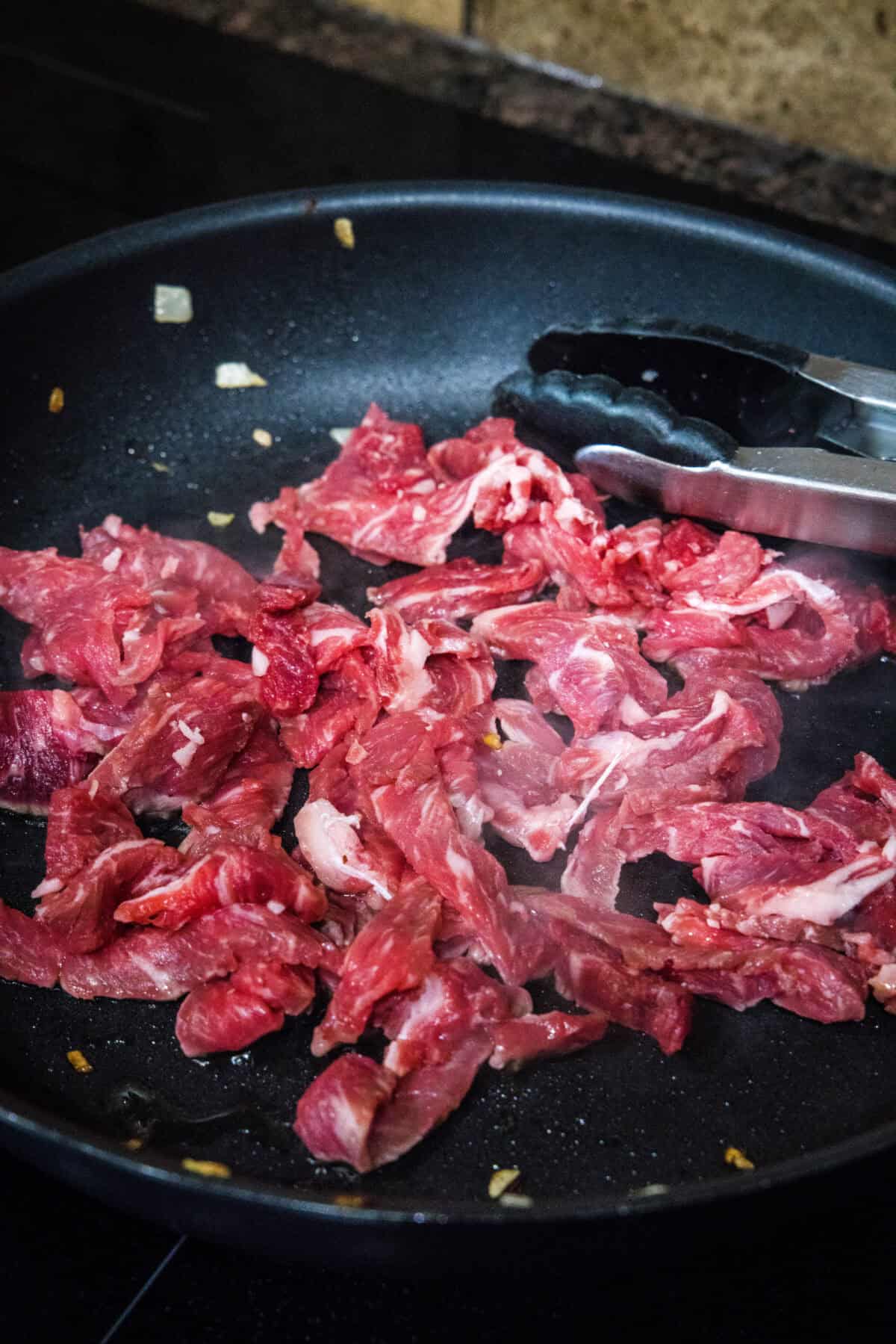 adding sliced ribeye to the pan