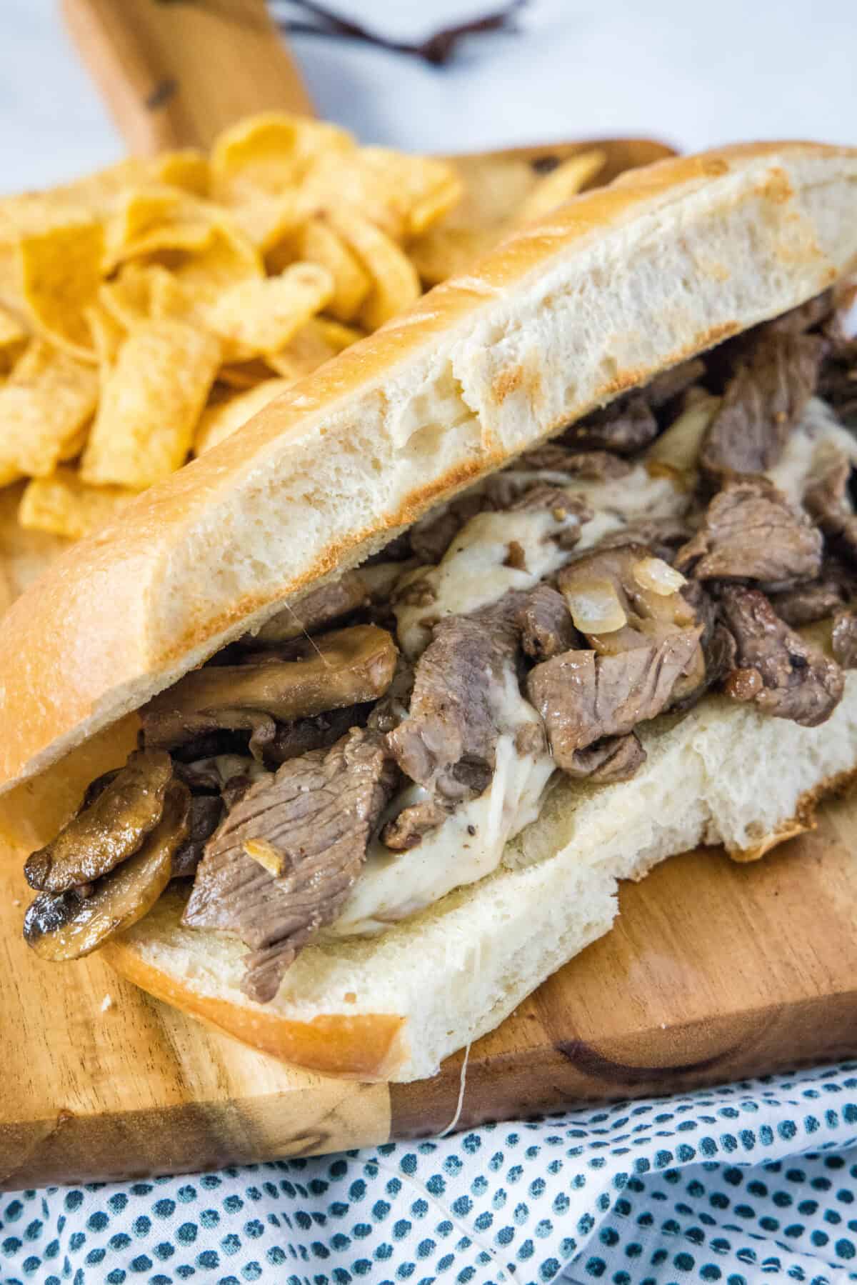 Philly Cheesesteaks | @Dinnersdishesdessert philly cheesesteak in a cutting board