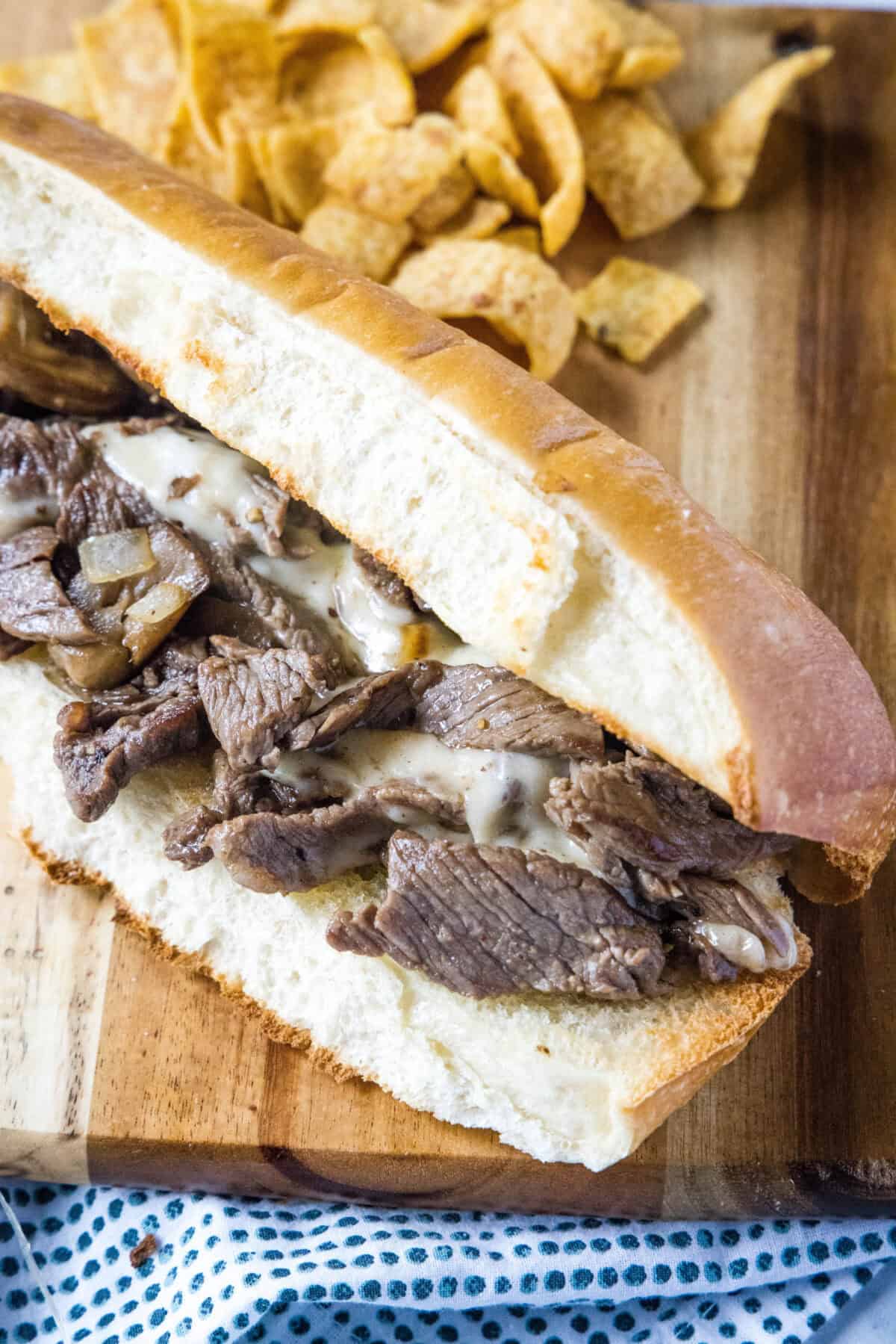 looking down on a philly cheesesteak on a cutting board
