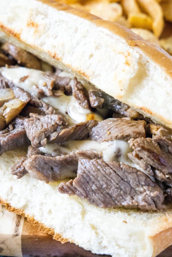 cropped close up cheesesteak on a cutting board