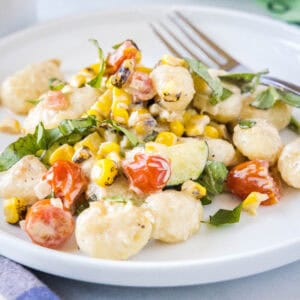This Summer Gnocchi recipe is a creamy, easy weeknight dinner loaded with fresh corn, zucchini, and tomatoes. It's a delicious way to use up summer produce in just 25 minutes.