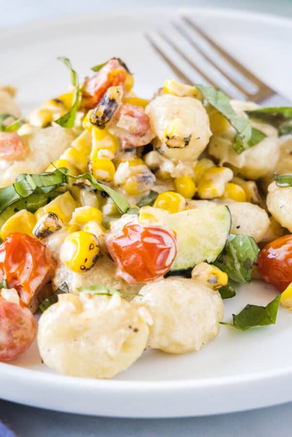 This Summer Gnocchi recipe is a creamy, easy weeknight dinner loaded with fresh corn, zucchini, and tomatoes. It's a delicious way to use up summer produce in just 25 minutes.
