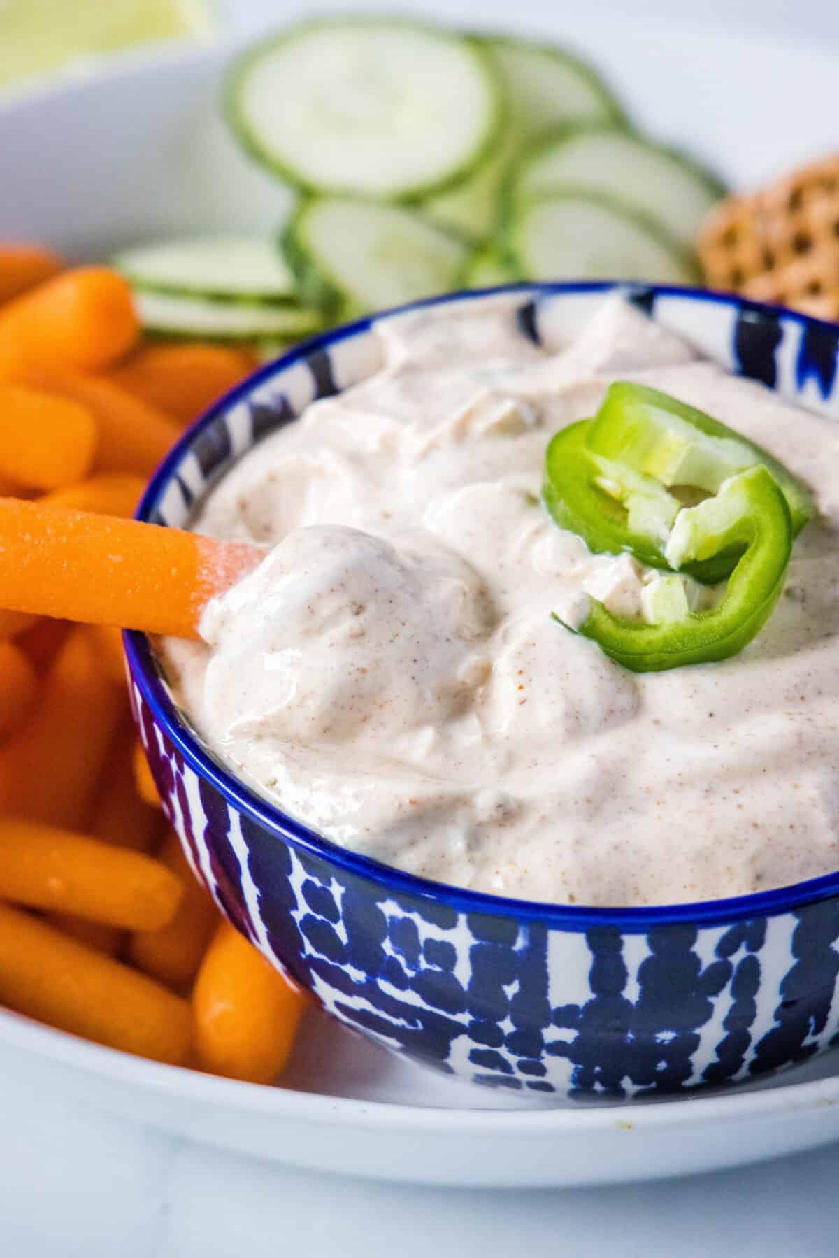 dipping a carrot in yogurt dip