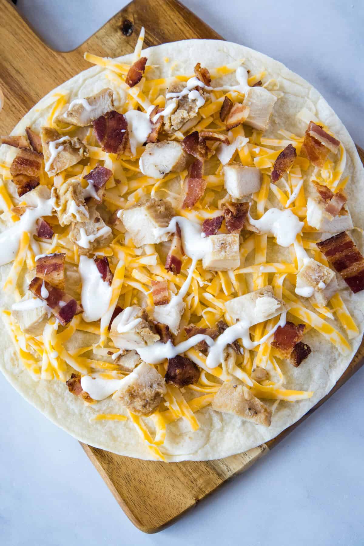 assembling bacon ranch chicken quasadilla