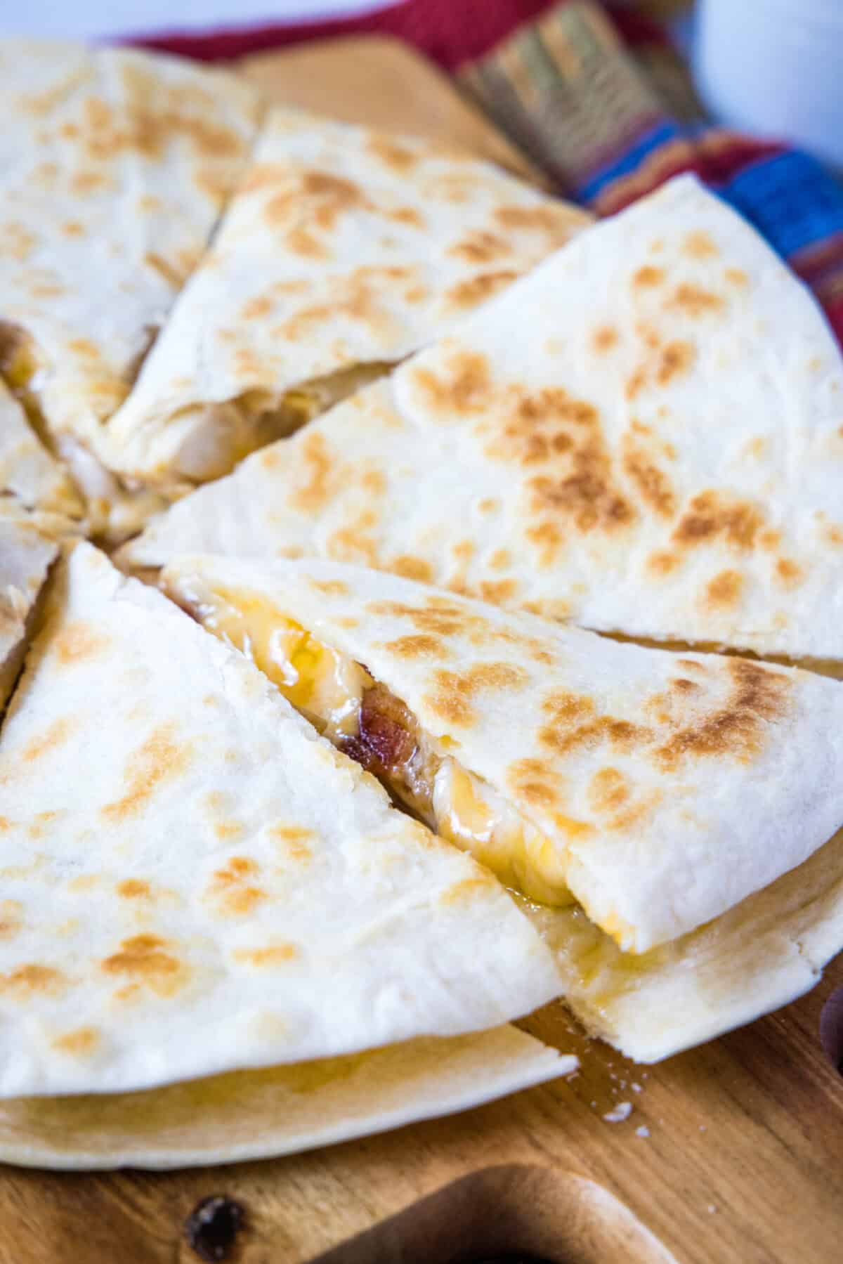 cut chicken quesadilla on a cutting board