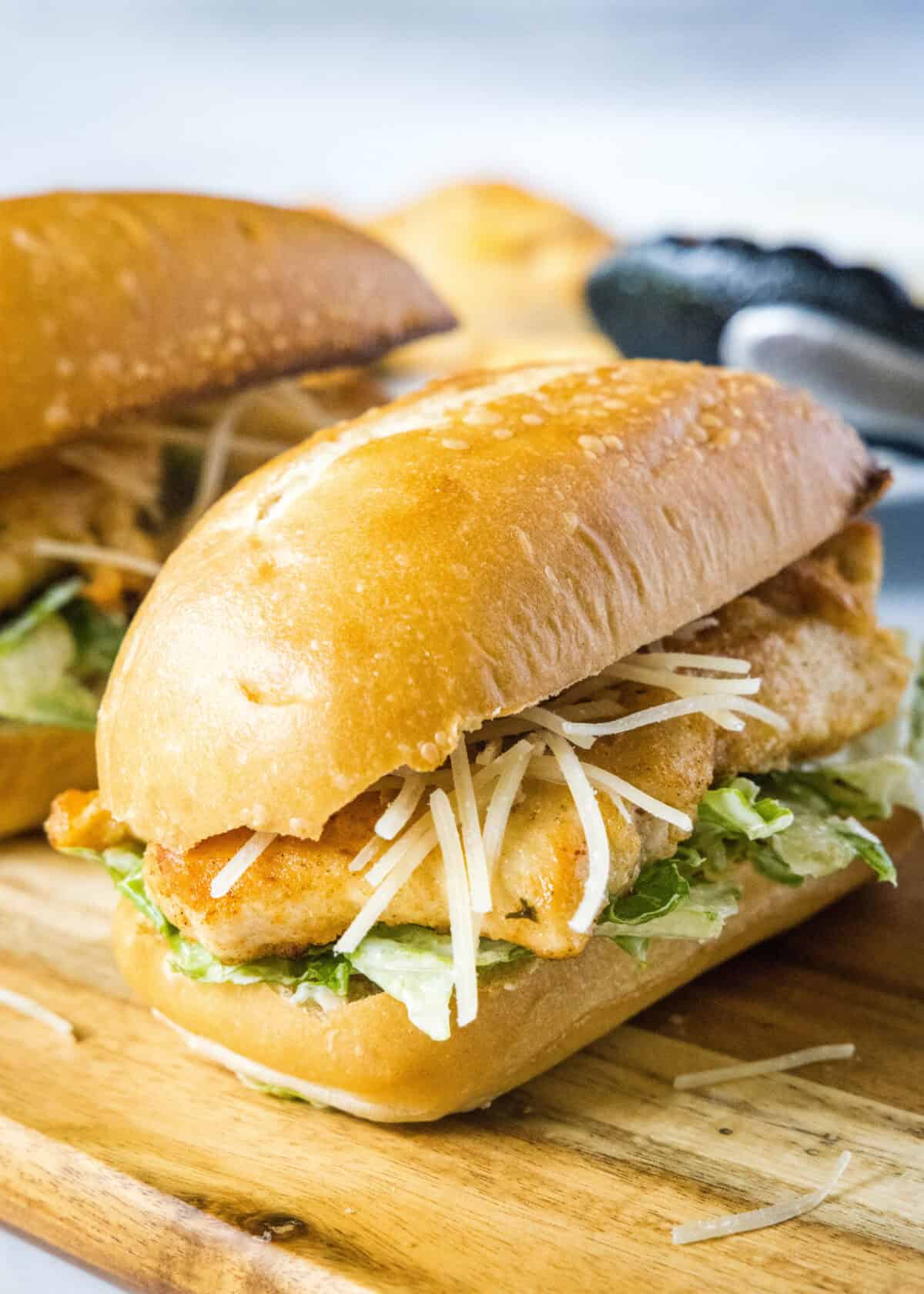 chicken caesar sandwich on a cutting board