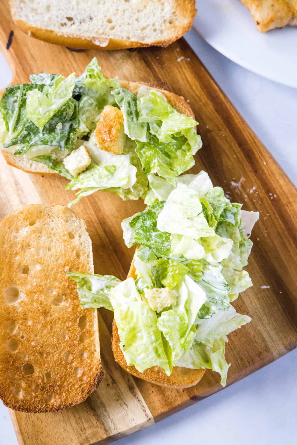 adding lettuce to buns