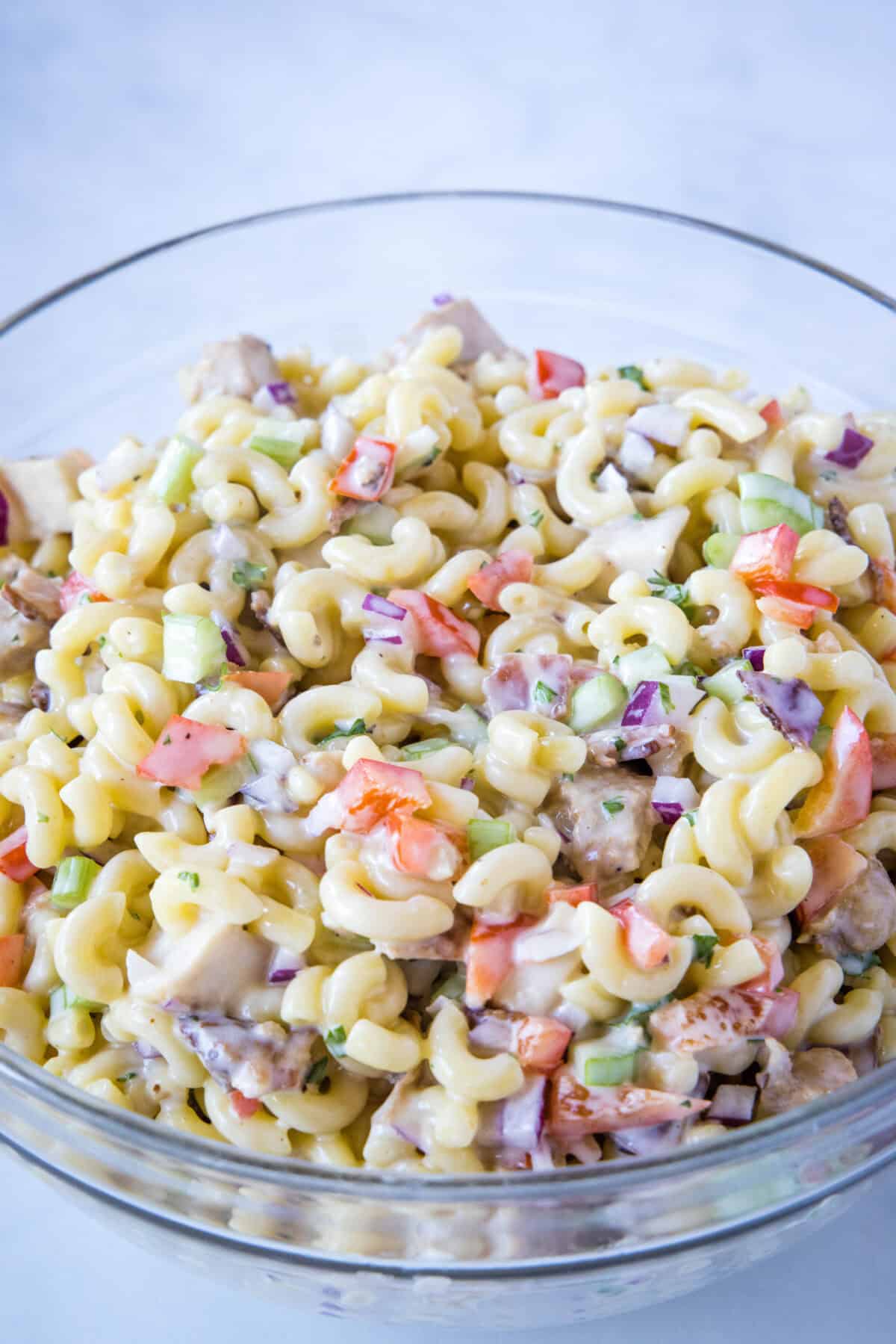 chicken macaroni salad mixed together in mixing bowl