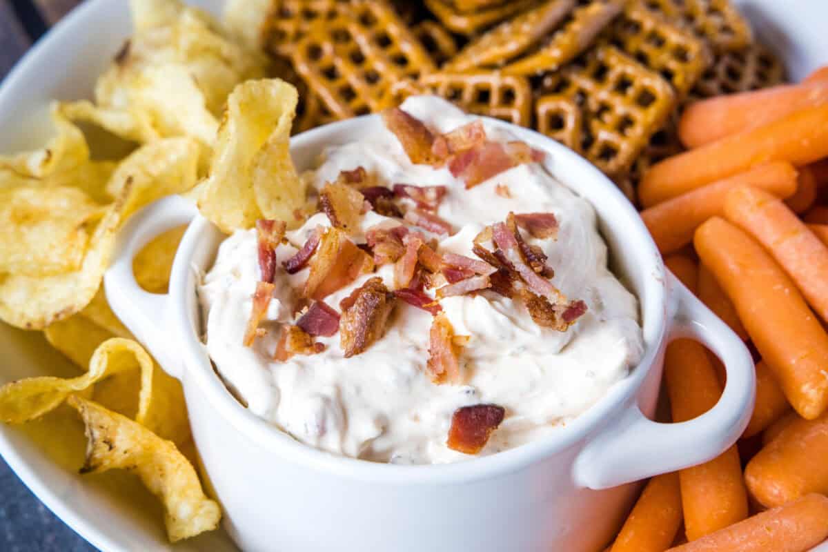 This Chipotle Bacon Ranch Dip is smoky, creamy, and ready in 5 minutes flat. Just stir together Greek yogurt, ranch seasoning, crispy bacon, and chipotle for the easiest make-ahead party dip.