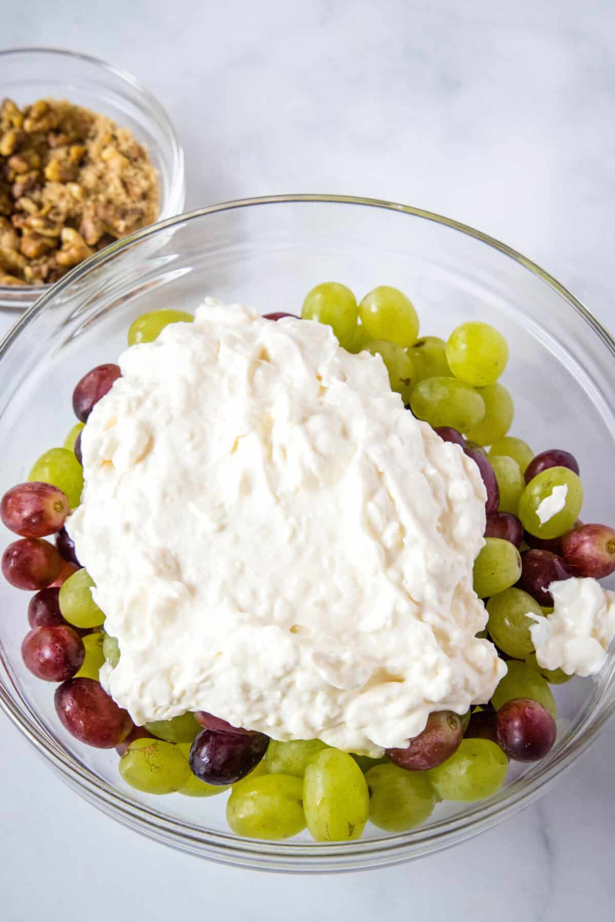 adding sweet cream dressing to grapes