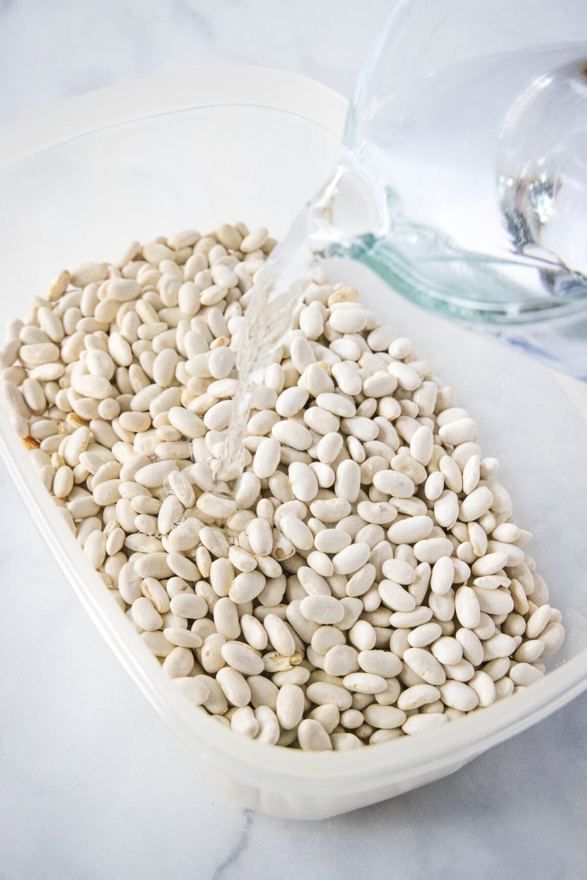 pouring water over dried beans
