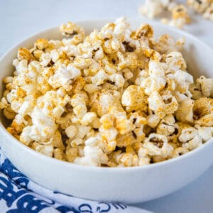 cropped close up spicy popcorn in white bowl