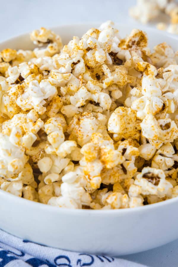 cropped close up spicy popcorn in white bowl