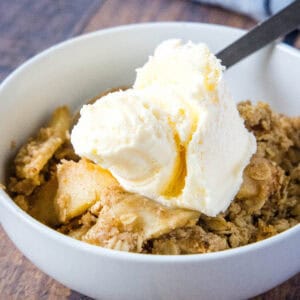 close up apple crisp with ice cream in a bowl
