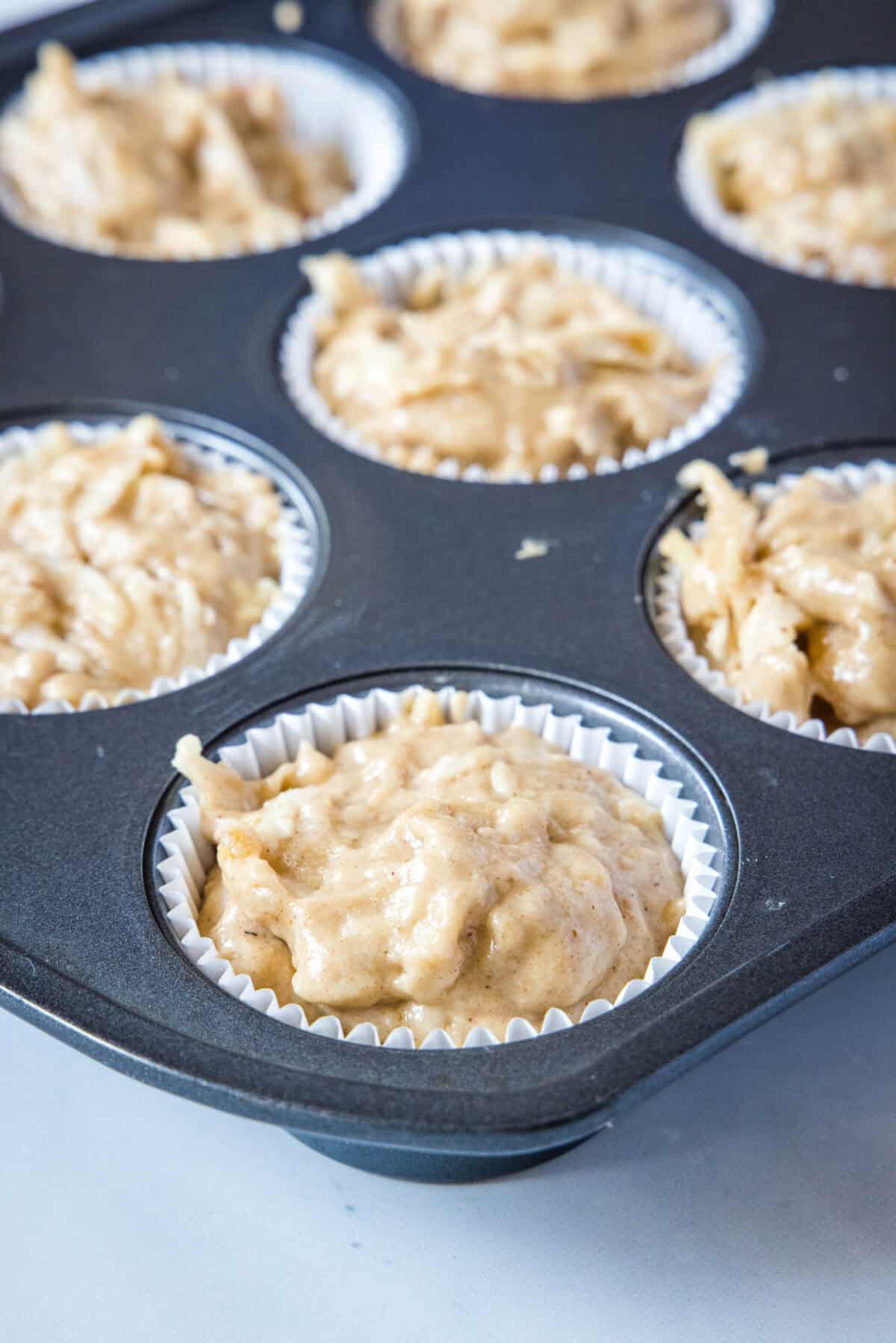 apple cupcake batter in muffin in