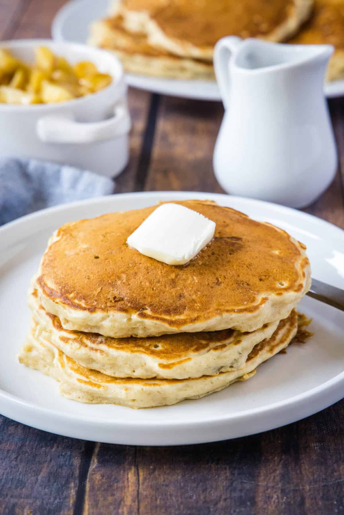 stacked pancakes with butter on top