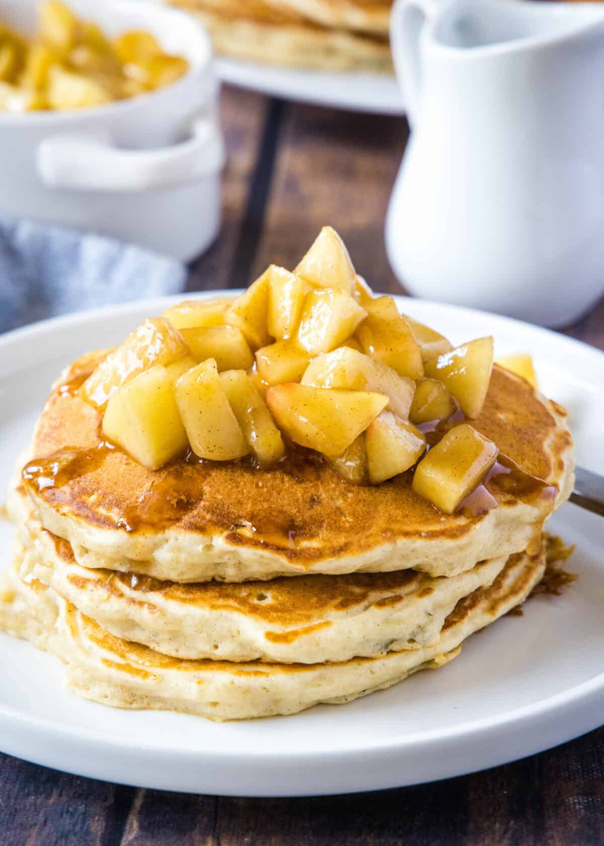 stacked apple pancakes on a plate