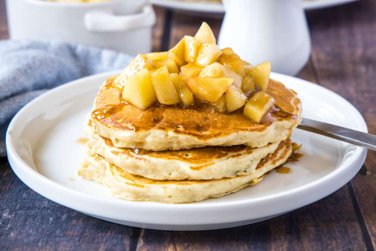 These Apple Pancakes are the ultimate fall breakfast! Fluffy pancakes are packed with shredded apple and cinnamon, then topped with an easy brown sugar sautéed apple topping. Made from scratch in under 30 minutes — perfect for a cozy weekend morning or holiday brunch. Save this recipe for the best apple pancakes you'll ever make!