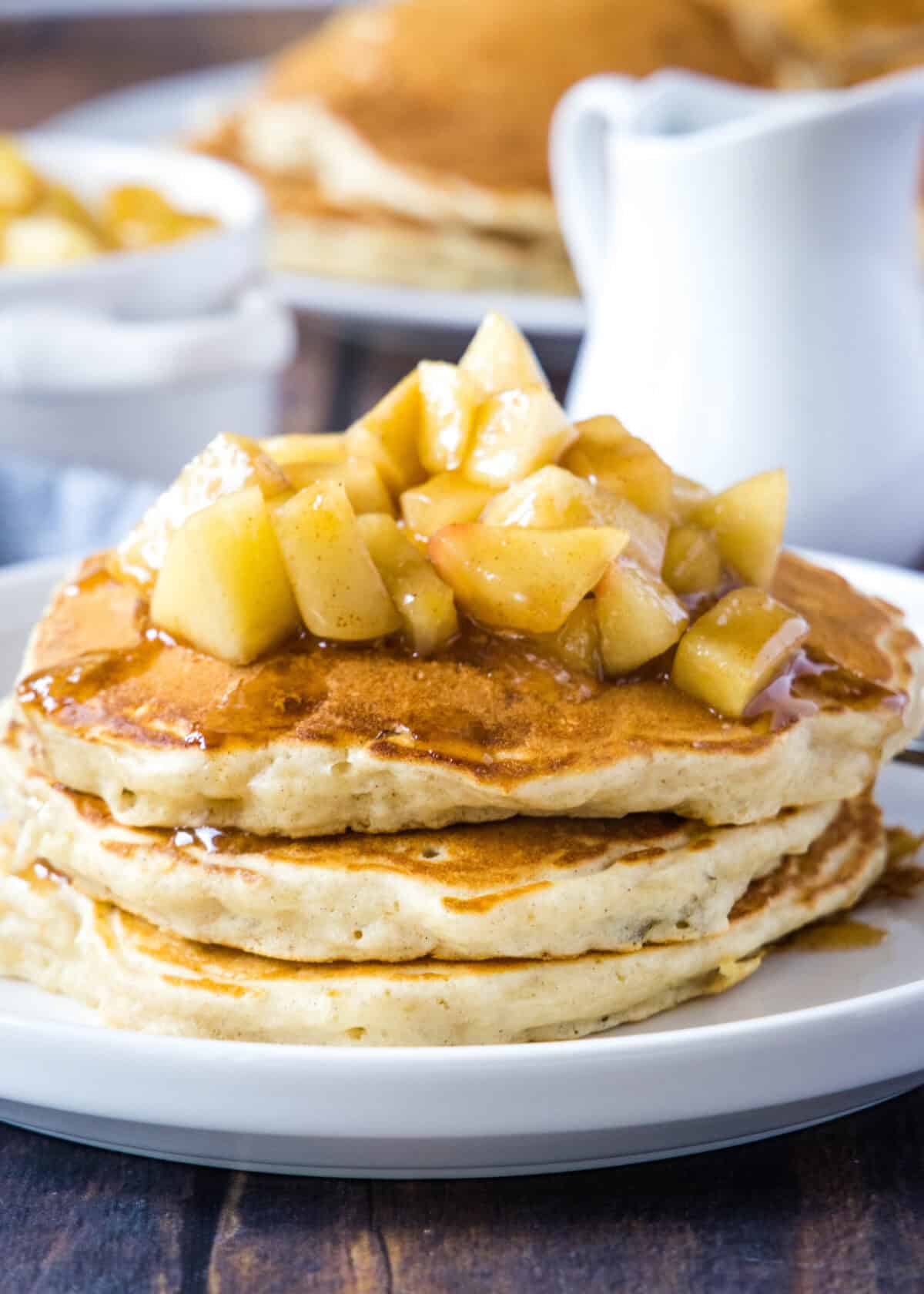 apple pancakes topped with apples on a plate